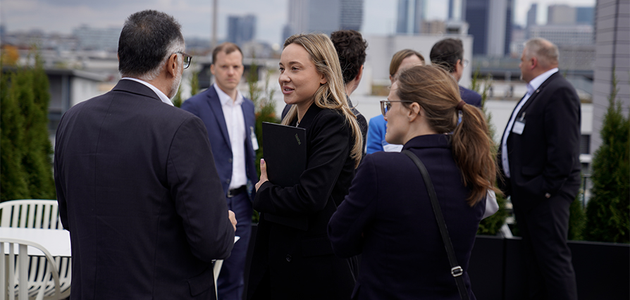 Group of business people standing outside talking to each other